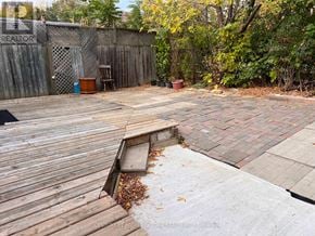 Brampton (Brampton South) apartment for rent - A backyard with a wooden deck and a brick patio.
