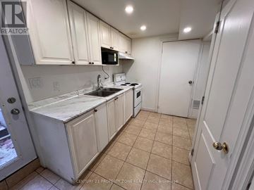 Brampton (Brampton South) apartment for rent - A kitchen with white cabinets and appliances.