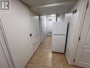 Brampton (Brampton South) apartment for rent - A white kitchen with tile flooring and white appliances.