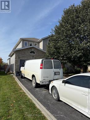 Kingston (City Northwest) apartment for rent - A white van and a white car are parked in front of a house.