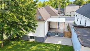 London South (South I) apartment for rent - A white house with a brown roof is surrounded by a green lawn.