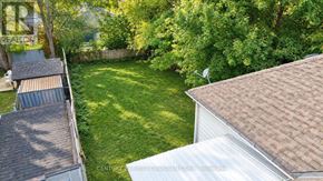 London South (South I) apartment for rent - A backyard with a white house and a green lawn.