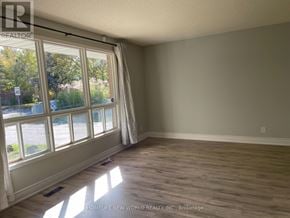 East Gwillimbury (Holland Landing) apartment for rent - A room with a window showing a parking lot outside.