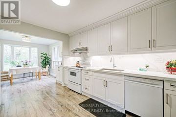 East Gwillimbury (Holland Landing) apartment for rent - A well-lit kitchen with white cabinets and appliances.