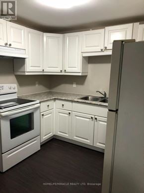 Barrie (Northwest) apartment for rent - A kitchen with white cabinets and appliances.