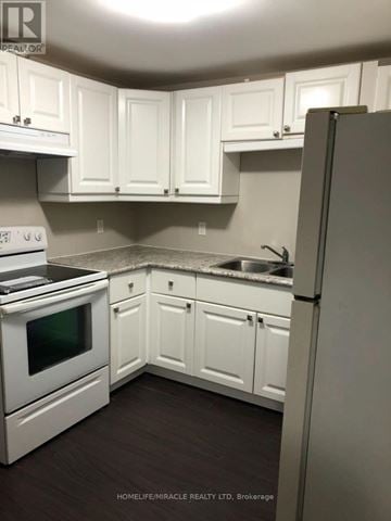 Barrie (Northwest) apartment for rent - A kitchen with white cabinets and appliances.