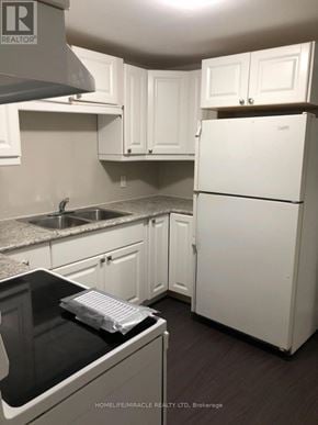 Barrie (Northwest) apartment for rent - A kitchen with white appliances and cabinets.