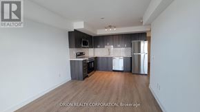 Pickering (Bay Ridges) condo for rent - A kitchen with a refrigerator, microwave, and oven.