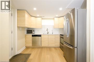 Burlington apartment for rent - A modern kitchen with wooden cabinets and stainless steel appliances.