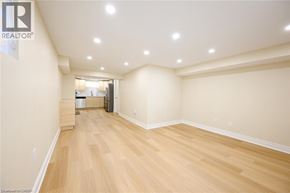Burlington apartment for rent - A room with wooden flooring and a realtor logo on the wall.
