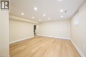 Burlington apartment for rent - A spacious room with wooden flooring and recessed lighting.