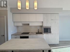 Toronto (Mount Pleasant West) condo for rent - A modern kitchen with a large island in the middle.