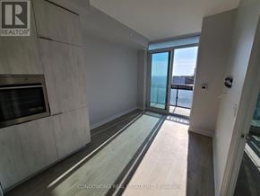 Toronto (Mount Pleasant West) condo for rent - A spacious room with a large window overlooking a balcony.