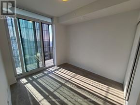 Toronto (Mount Pleasant West) condo for rent - A sunlit room with a sliding glass door leading outside.