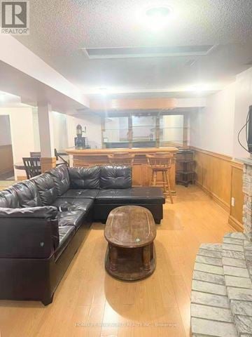 Toronto (Milliken) apartment for rent - A living room with a black leather couch and a wooden coffee table.