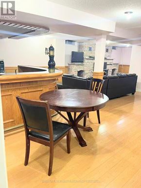 Toronto (Milliken) apartment for rent - A brown wooden table with a black chair in front of a white wall.