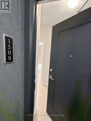Mississauga (Fairview) condo for rent - A black door with a silver handle and a sign on the wall that says 1509.