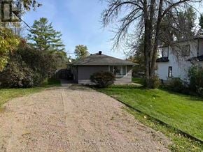 Ramara apartment for rent - A house with a grey roof and a gravel driveway.