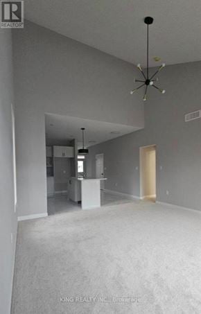 Cambridge townhouse for rent - A spacious room with a chandelier and a white cabinet is on the market.