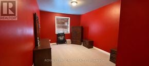 St. Catharines (Oakdale) townhouse for rent - A room with red walls and a flat screen TV.
