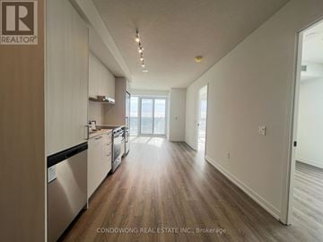 Vaughan (Concord) condo for rent - A kitchen with white cabinets and a stainless steel dishwasher.