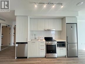 Vaughan (Concord) condo for rent - A kitchen with white cabinets and stainless steel appliances.