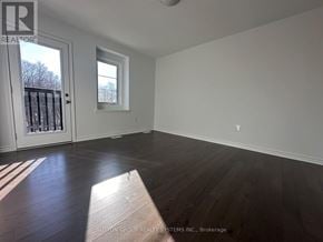 Oakville (Go Glenorchy) townhouse for rent - A room with a door and a window, and a wooden floor.