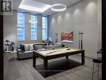 Toronto (Waterfront Communities) condo for rent - A living room with a pool table and a couch.