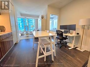 Toronto (Waterfront Communities) condo for rent - A well-lit room with a desk, chairs, and a computer setup.