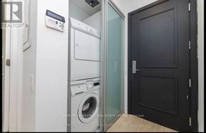 Toronto (Mimico) condo for rent - A laundry room with a washer and dryer stacked on top of each other.