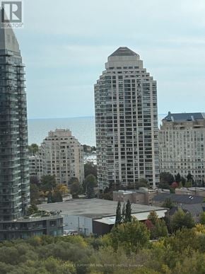 Toronto (Mimico) condo for rent - A cityscape with buildings and trees in the foreground.