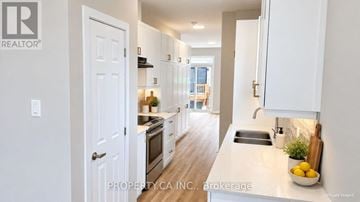 Ottawa townhouse for rent - A white kitchen with a sink and a window.