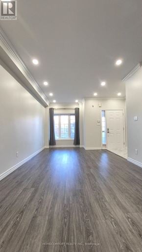 Richmond Hill (Langstaff) apartment for rent - A spacious room with wood flooring and recessed lighting.