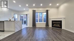 Richmond Hill (Langstaff) apartment for rent - A spacious living room with a fireplace and a kitchen area in the background.