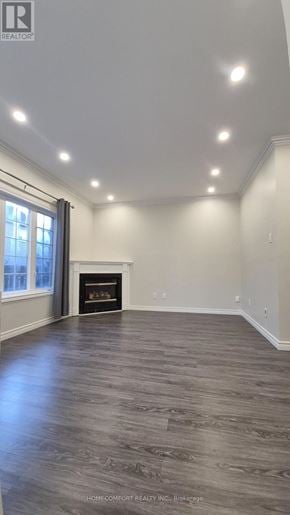 Richmond Hill (Langstaff) apartment for rent - A spacious living room with a fireplace and wood flooring.