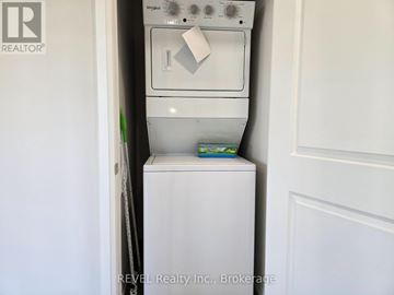 St. Catharines (Oakdale) condo for rent - A white dishwasher is in a small kitchen.