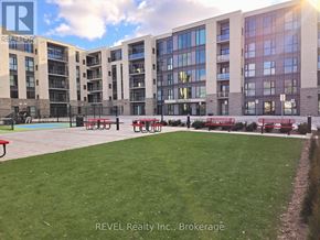 St. Catharines (Oakdale) condo for rent - A large grassy area in front of apartment buildings.