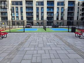 St. Catharines (Oakdale) condo for rent - A courtyard with a basketball court and a bench.