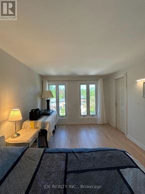Toronto (Hillcrest Village) apartment for rent - A bedroom with a bed, nightstand, and window.