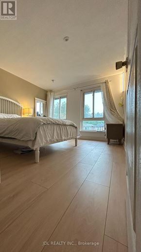 Toronto (Hillcrest Village) apartment for rent - A bedroom with a large bed and a window with curtains.