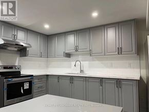 Toronto (Pleasant View) apartment for rent - A kitchen with grey cabinets and a white countertop.
