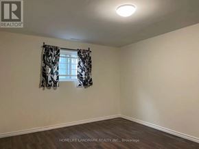 Toronto (Pleasant View) apartment for rent - A room with a window and curtains, with the logo "REALTOR" on the wall.