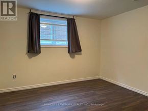 Toronto (Pleasant View) apartment for rent - A room with a window and a wooden floor.