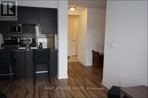 Toronto (Bendale) condo for rent - A kitchen with a bar stool and a counter.