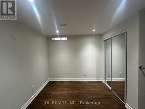 Markham (Buttonville) apartment for rent - A room with wooden flooring and white walls, with a glass door on the right side.
