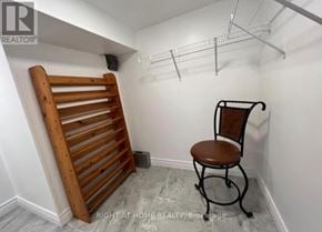 Brock (Beaverton) apartment for rent - A small room with a chair and a wooden rack.