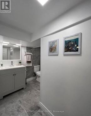 Brock (Beaverton) apartment for rent - A bathroom with a toilet, sink, and a painting on the wall.