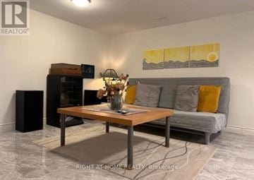 Brock (Beaverton) apartment for rent - A living room with a grey couch, a wooden coffee table, and a painting on the wall.