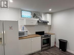 Whitchurch-Stouffville apartment for rent - A kitchen with white cabinets and a black trash can.