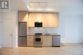 Oakville (Jm Joshua Meadows) condo for rent - A modern kitchen with wooden cabinets and stainless steel appliances.
